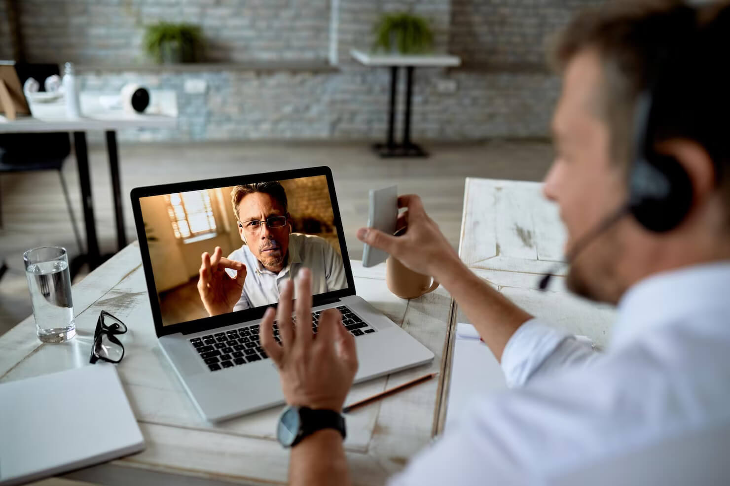 Businessman using laptop to run a video call with potential candidate