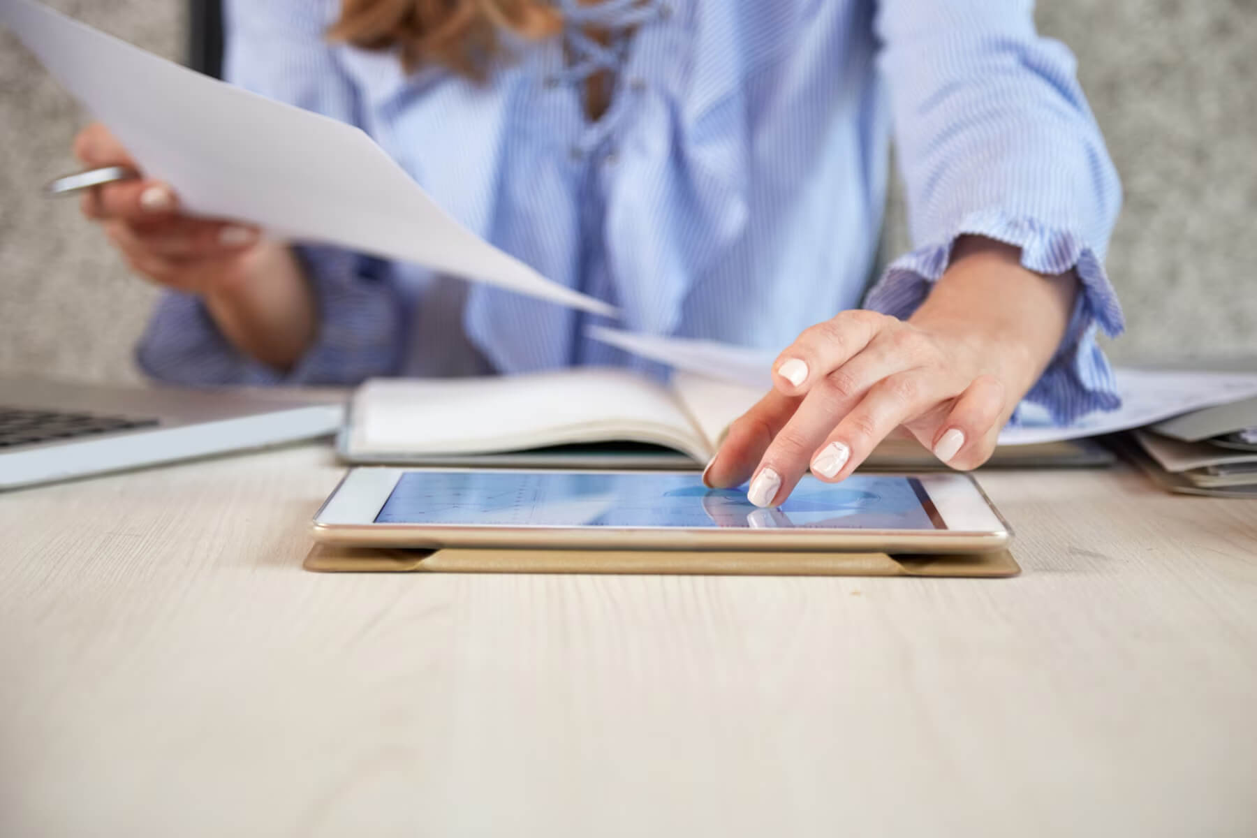 Woman reading on her tablet a digital employee handbook