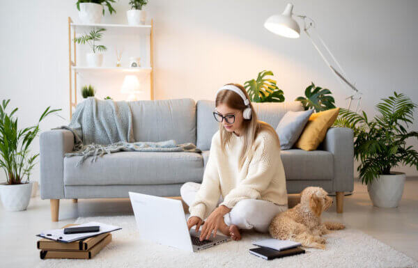 Woman working from home and looking up remote work trends for augmented software developers
