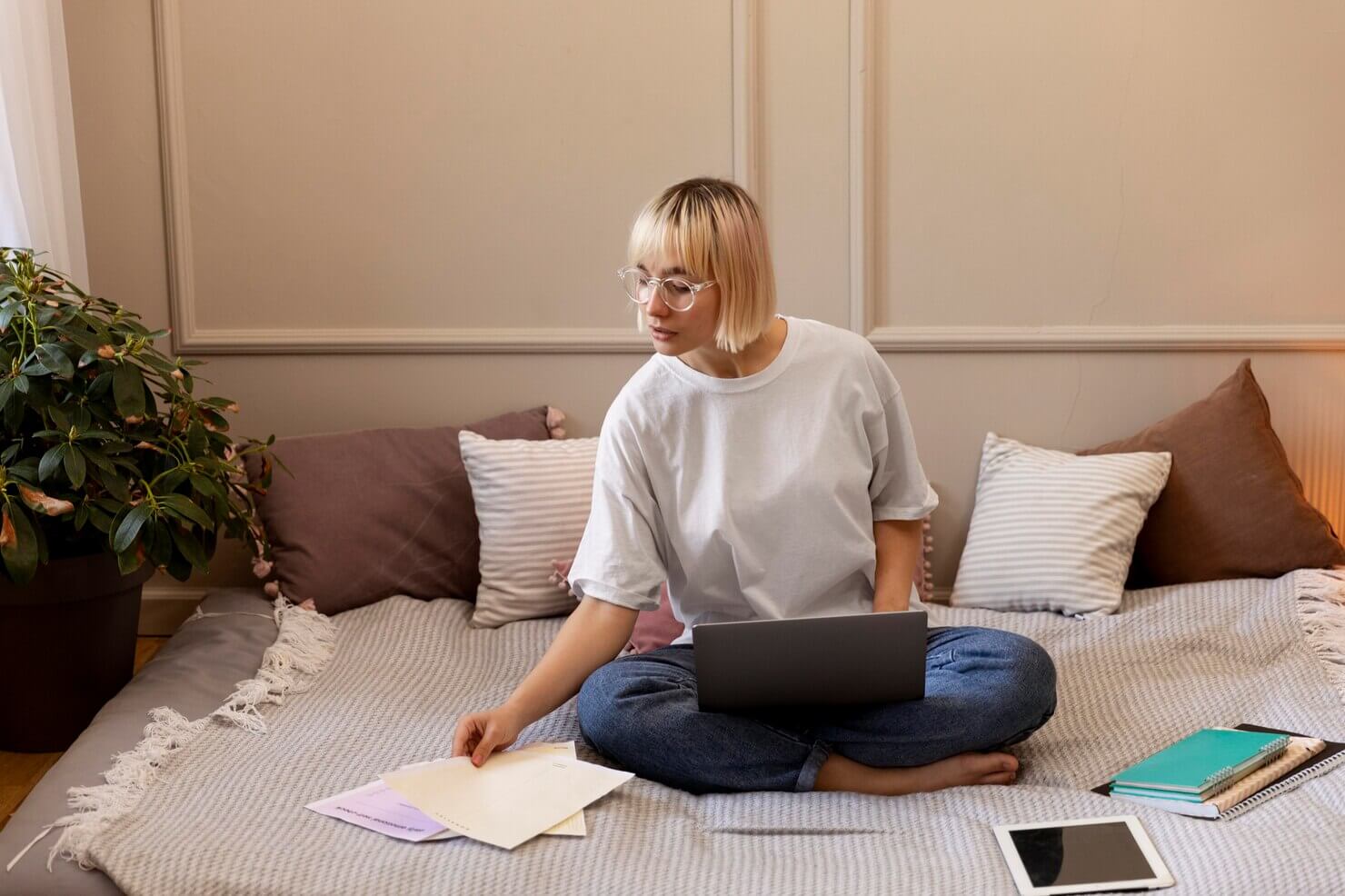 Young blonde woman working from home on her laptop. She has a better work-life balance